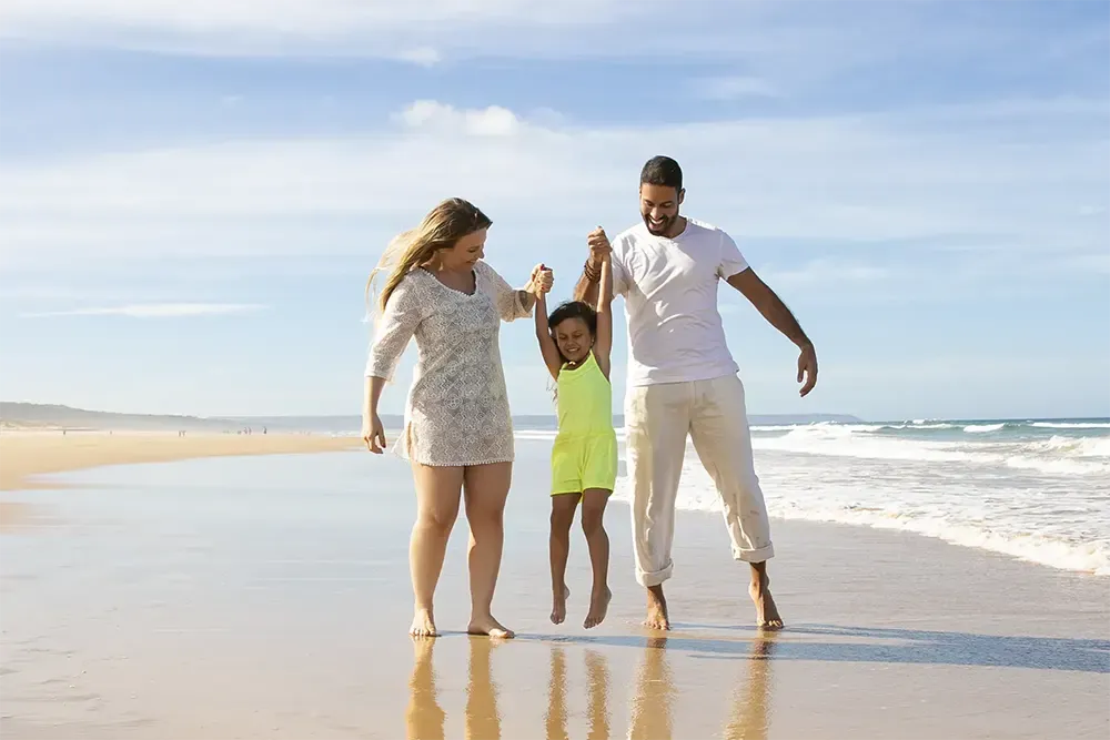Família caminhando na praia durante viagem organizada por agência de turismo em Salvador